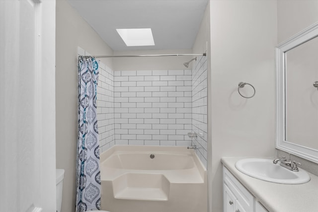 full bathroom with shower / tub combo with curtain, vanity, toilet, and a skylight