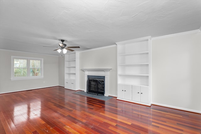 unfurnished living room featuring hardwood / wood-style flooring, ornamental molding, built in features, and a textured ceiling