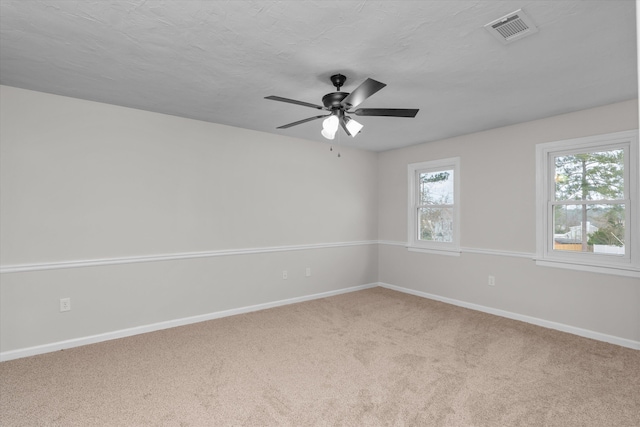 carpeted empty room with a textured ceiling and ceiling fan