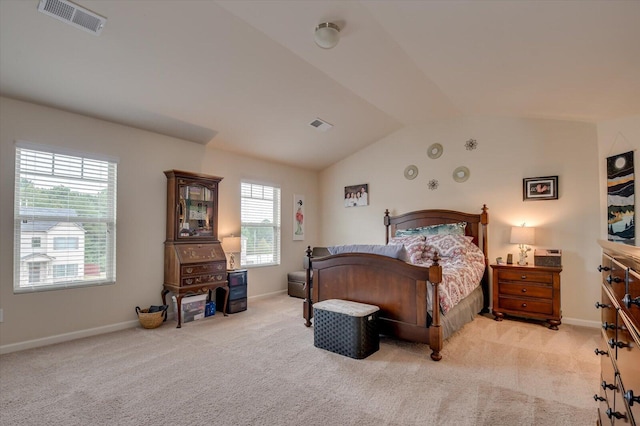 bedroom with lofted ceiling and light carpet