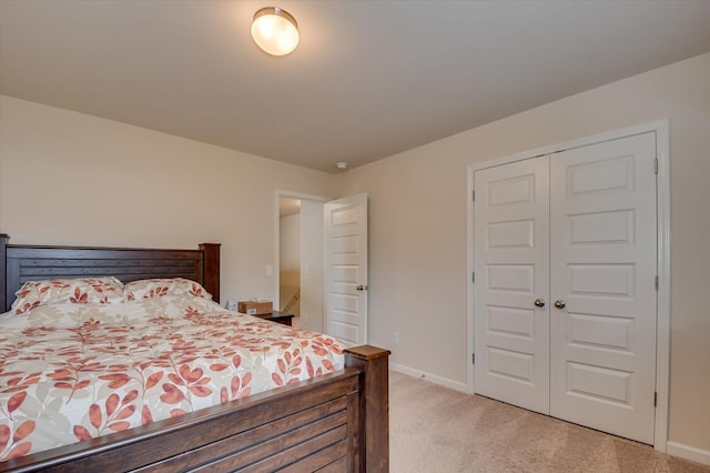 bedroom featuring light carpet and a closet