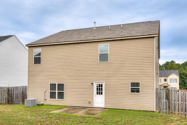 rear view of property featuring central air condition unit, a yard, and a patio