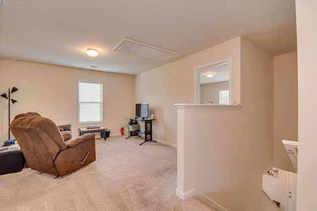 living area featuring a healthy amount of sunlight and carpet floors