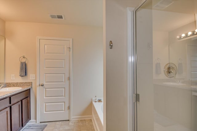 bathroom featuring vanity and shower with separate bathtub