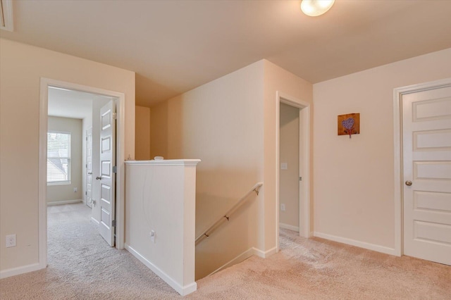 hallway with light colored carpet