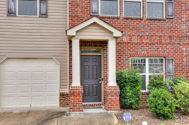 view of exterior entry featuring a garage