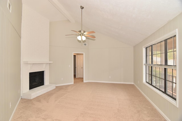 unfurnished living room featuring vaulted ceiling with beams, ceiling fan, light colored carpet, and a brick fireplace