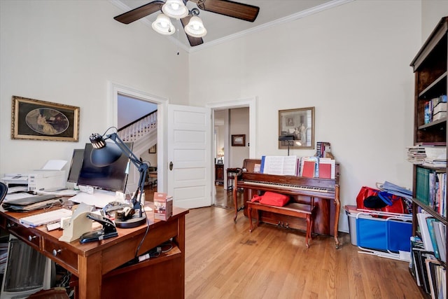 office area with high vaulted ceiling, ceiling fan, crown molding, and light hardwood / wood-style flooring