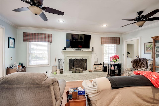 living room featuring a fireplace, ceiling fan, and crown molding