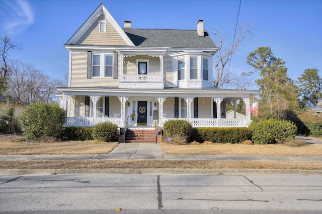 victorian house featuring a porch