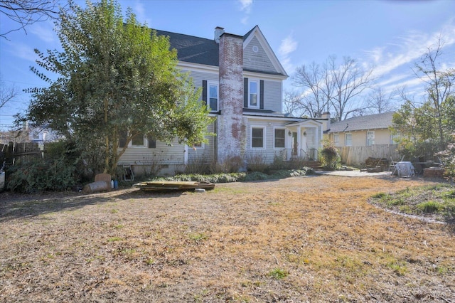 back of house with a yard