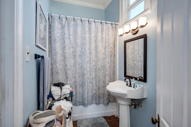 bathroom with a shower with shower curtain and crown molding