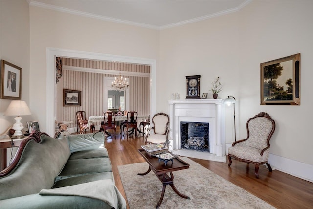 living room featuring hardwood / wood-style floors, crown molding, and a chandelier