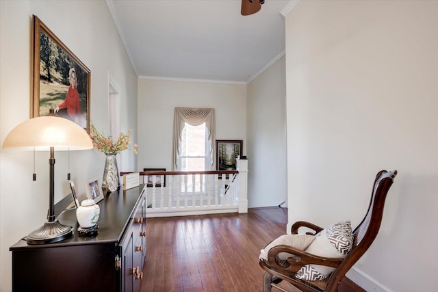 sitting room with dark hardwood / wood-style flooring and crown molding