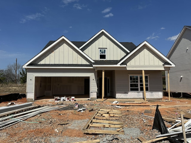 view of front of property featuring board and batten siding and roof with shingles