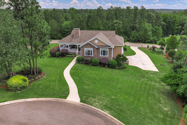 2051 Waterbridge Ln, Aiken, SC 29803 - view of front of property featuring a forest view, a chimney, a front lawn, and stone siding
