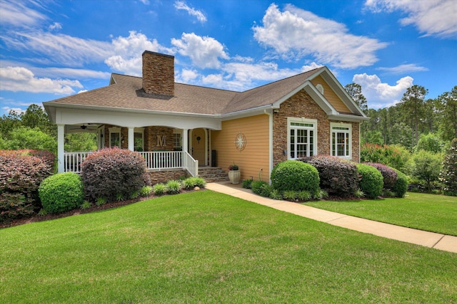 2051 Waterbridge Ln, Aiken, SC 29803 - view of front of home with a chimney, a front yard, covered porch, stone siding, and a shingled roof