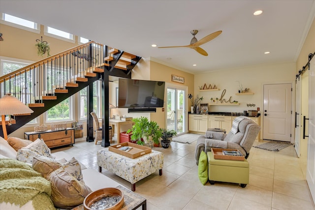 2051 Waterbridge Ln, Aiken, SC 29803 - living room featuring ornamental molding, a ceiling fan, light tile patterned flooring, a barn door, and stairway