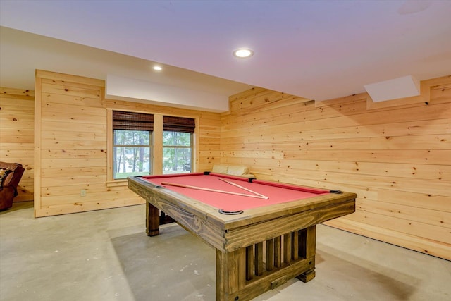 playroom with concrete floors, wooden walls, and pool table