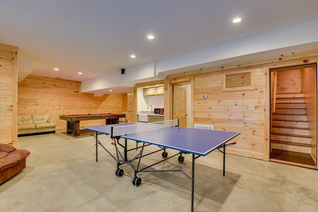 game room featuring wooden walls