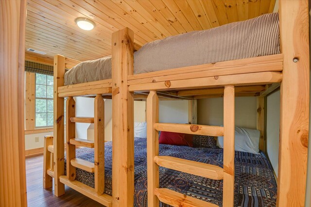 bedroom featuring hardwood / wood-style floors and wooden ceiling