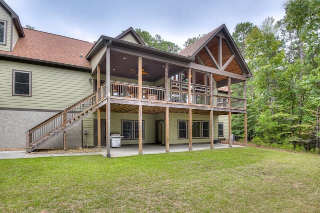 back of house with a sunroom, a lawn, ceiling fan, a patio area, and a deck