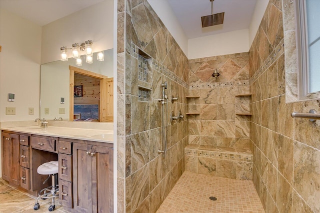 bathroom featuring vanity and tiled shower