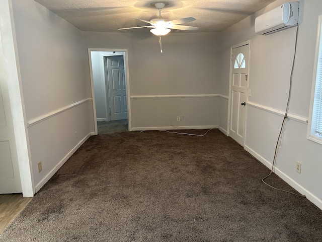carpeted foyer featuring ceiling fan, a wall mounted air conditioner, and baseboards