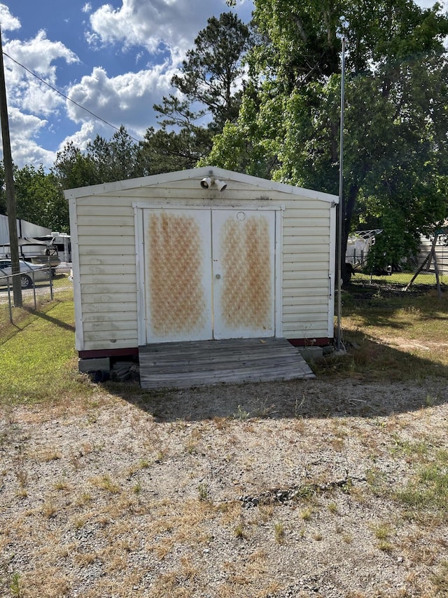 view of shed with fence