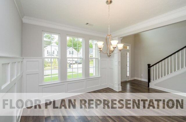 entrance foyer featuring dark hardwood / wood-style floors, crown molding, and an inviting chandelier