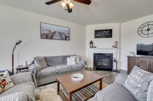 living room featuring ceiling fan and light hardwood / wood-style flooring