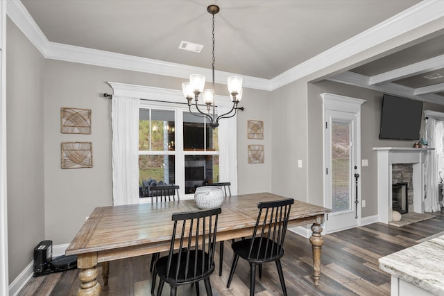 dining room with a fireplace, dark wood finished floors, and crown molding