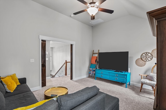 living area with carpet, visible vents, vaulted ceiling, and baseboards