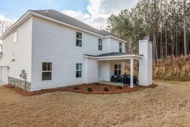 rear view of house featuring a yard