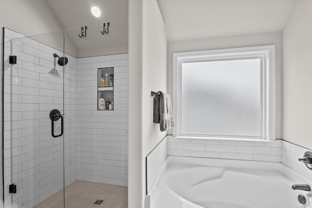 bathroom with a garden tub and a shower stall