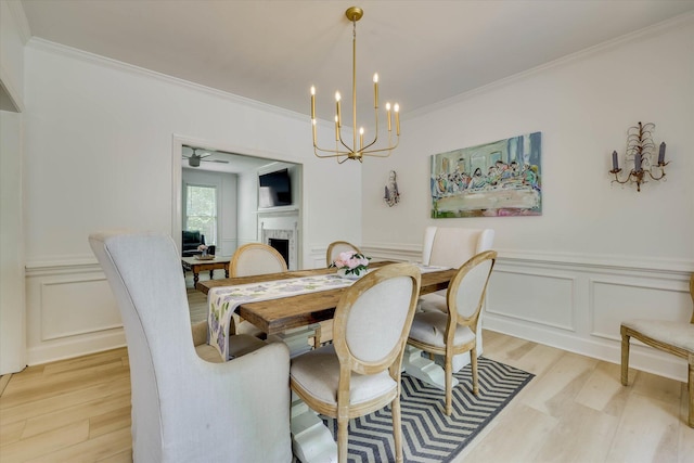 3555 Watervale Way, Martinez, GA 30907 - dining room featuring light wood finished floors, a decorative wall, a fireplace, crown molding, and a chandelier