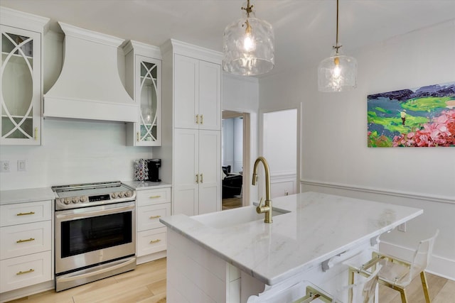 3555 Watervale Way, Martinez, GA 30907 - kitchen featuring stainless steel range with electric cooktop, wall chimney exhaust hood, light wood-type flooring, and white cabinets