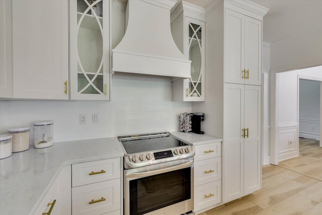 3555 Watervale Way, Martinez, GA 30907 - kitchen featuring electric stove, custom exhaust hood, white cabinets, glass insert cabinets, and light stone countertops