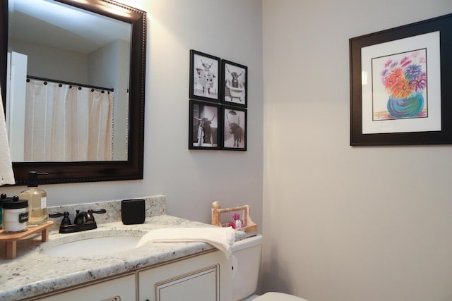 bathroom featuring toilet and vanity