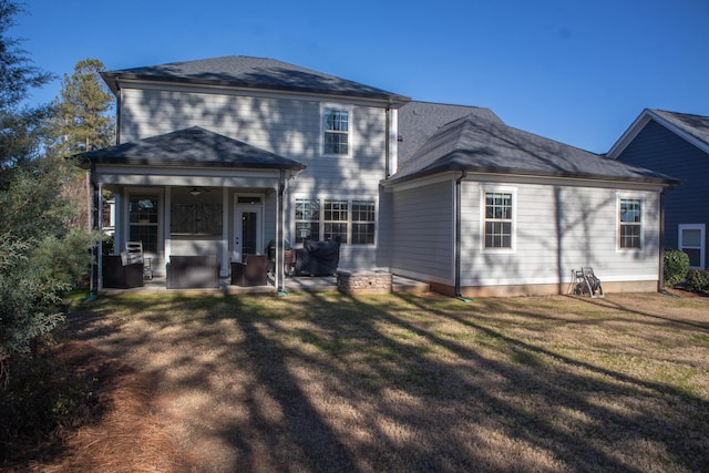 rear view of house with a lawn