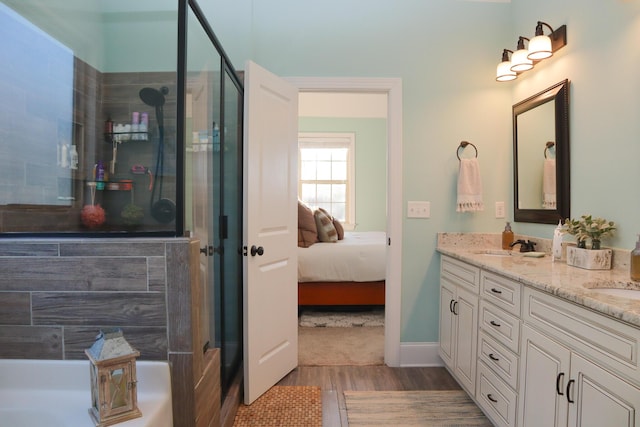 bathroom featuring hardwood / wood-style floors, vanity, and an enclosed shower