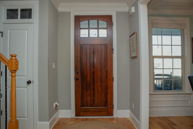 foyer featuring crown molding and light hardwood / wood-style flooring