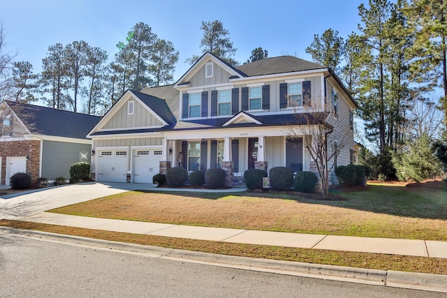 craftsman-style home featuring a front lawn and a garage