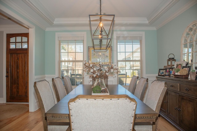 dining room featuring ornamental molding and light wood-type flooring