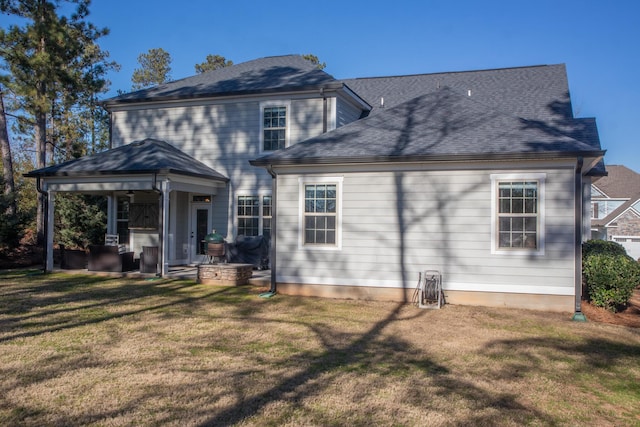 back of house with a patio and a yard