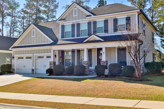 craftsman inspired home with a garage, covered porch, and a front yard