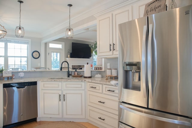 kitchen with decorative backsplash, sink, white cabinetry, appliances with stainless steel finishes, and light stone counters