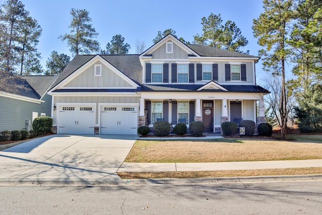 craftsman inspired home with a front yard and a garage