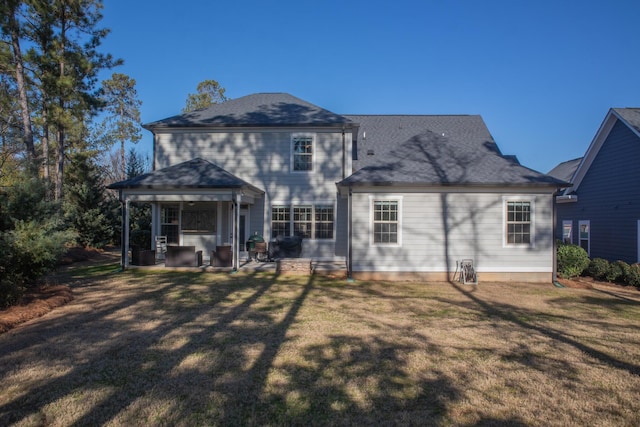 rear view of house featuring a yard and a patio