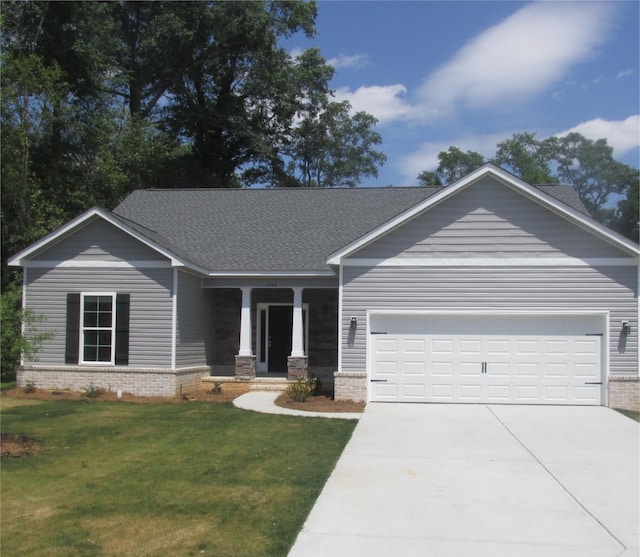 view of front of property with a front lawn and a garage